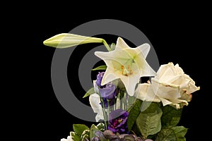 Lily and bud, lisianthus, rose, hortensia bouquet macro on black background