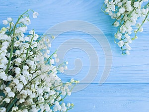 Lily of the valley on blue wooden celebration spring flowers greetings