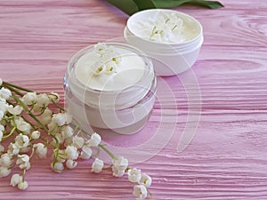 Lily of the valley flower therapy shower products cosmetic on pink wooden