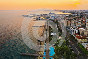 Limassol promenade at sunset, Cyprus. Aerial panoramic view of evening Limassol with Molos Park from above, drone photo