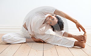 Limber and invigorated. A pretty young woman doing stretches before a workout.