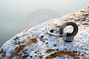 Ð¡limbing carabiner hook and trigger device in stone. Carabiner for mountaineering on rocky background.