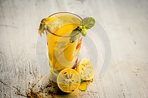 Limbo sharbat,lemon juice or Citrus Ã— limon juice with some leaves of mint in a transparent glass.