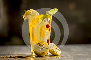 Limbo sharbat,lemon juice or Citrus Ã— limon juice with some leaves of mint in a transparent glass.