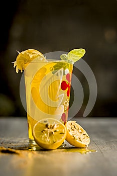 Limbo sharbat,lemon juice or Citrus Ã— limon juice with some leaves of mint in a transparent glass.