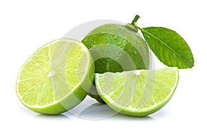 Fresh organic lime fruit with green leaf ,water droplets and cut in half slice isolated on white