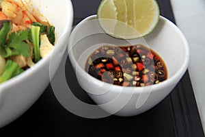 Lime and chili in soy sauce as condiment side dish Seafood curry asian food in bowl,