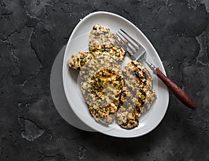 Lime, cilantro, garlic, mustard, olive oil marinated grilled chicken breast on a dark background, top view