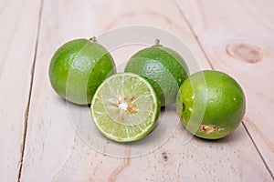 Lime. Fresh fruit on wood board background.