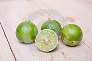 Lime. Fresh fruit on wood board background.
