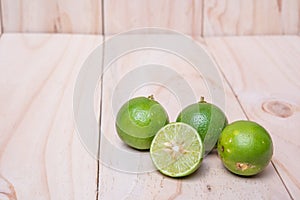 Lime. Fresh fruit on wood board background.