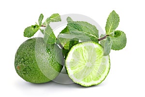 Lime. fruit with a half isolated on whiteFresh tasty lime fruit with mint leaves.