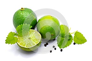 Lime fruit with melissa isolated on white