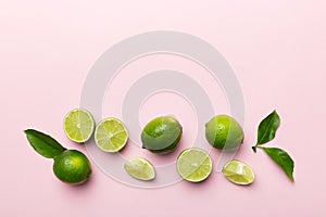 Lime fruits with green leaf and cut in half slice isolated on white background. Top view. Flat lay with copy space