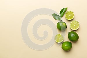 Lime fruits with green leaf and cut in half slice isolated on white background. Top view. Flat lay with copy space