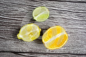 lime and fruits on wood background. top view. no photoshop used.