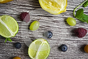 lime and fruits on wood background. top view. no photoshop used.