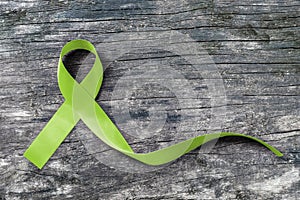 Lime Green ribbon for Lymphoma Cancer and mental health awareness for supporting and helping patient with illness bow isolated photo
