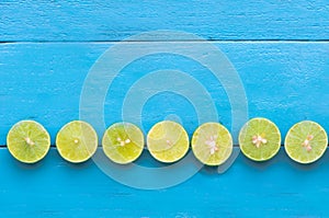 a Lime lemon are half cut and arrange to column on blue wooden b