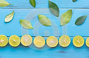 a Lime lemon are half cut and arrange to column on blue wooden b