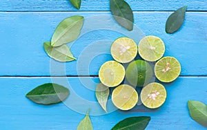 a Lime lemon are half cut on blue wooden background. Leadership