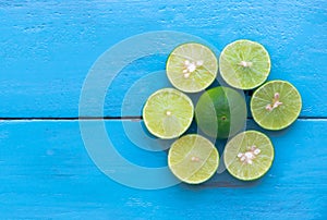 a Lime lemon are half cut on blue wooden background. Leadership