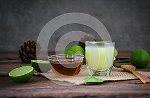 a Lime lemon with juice and honey in transparent glass with sac