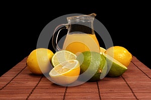 Lime, lemon and pitcher of juice