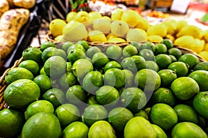 Lime and lemons background. Fresh organic lemons and lime on a local farmer food market on Bali island.