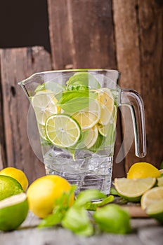 Lime lemons limonade, fresh herbs and ice in