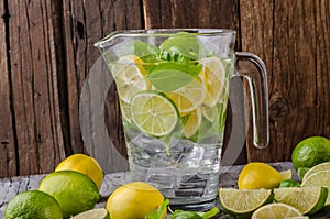 Lime lemons limonade, fresh herbs and ice in