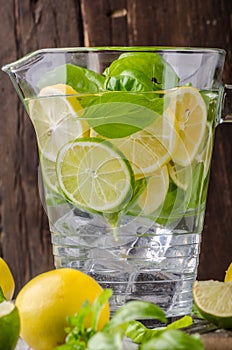 Lime lemons limonade, fresh herbs and ice in