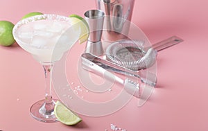 Lime margarita alcoholic cocktail with silver tequila, liqueur, lime juice, sugar syrup, salt and ice, festive trendy pink