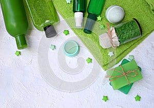 Lime mint composition beauty treatment products in green colors: shampoo, soap, bath salt, towel, oil. Various bath accessories. I