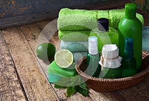 Lime mint composition beauty treatment products in green colors: shampoo, soap, bath salt, towel, oil. Various bath accessories. I