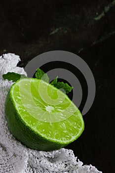 Lime and mint with white cloth on slate background