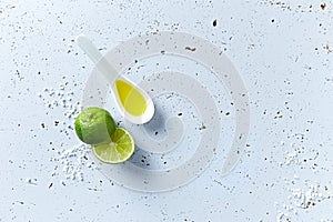 Lime, olive oil and sea salt on gray background; symbolic image