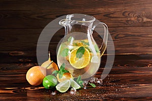 Lime, orange, mint - ingredients for a juice on a table background. A cocktail with rum, liquor and fruits. Copy space.