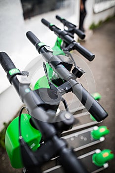 Lime-s e-scooters parked on sidewalk