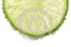 Lime Slice in Clear Fizzy Water Bubble Background