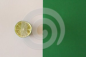 Lime slice on green and white background