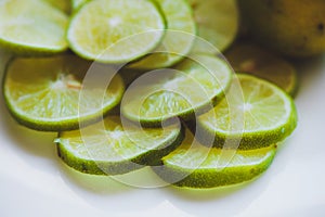 Lime slices background in green