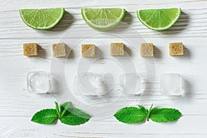 Lime slices, ice, mint and cubes of brown sugar. Ingredients for