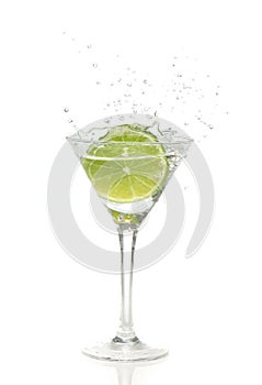 Lime splashing into a cocktail