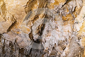 Lime stone stalactites in the cave - mineral formation that hangs from the cave's ceiling