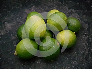 Limes laying in stone bowl for cocktail