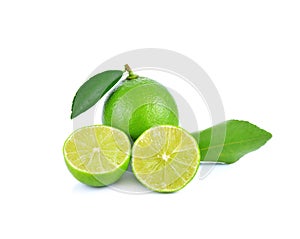 Limes with slices and leaves isolated on white