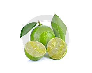 Limes with slices and leaves on white background