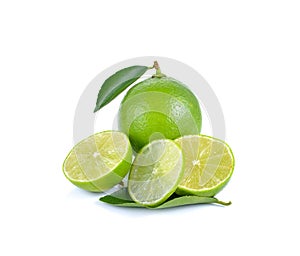 Limes with slices and leaves on white background