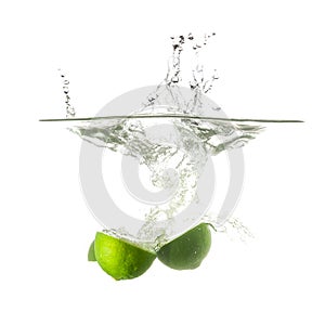Limes splash on water, isolated on white background.